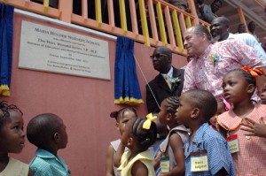 Minister of Education Ronald Jones (left) and co-founder and chairman of the Maria Holder Memorial Trust, Christopher Holder (right), unveiling the plaque.  