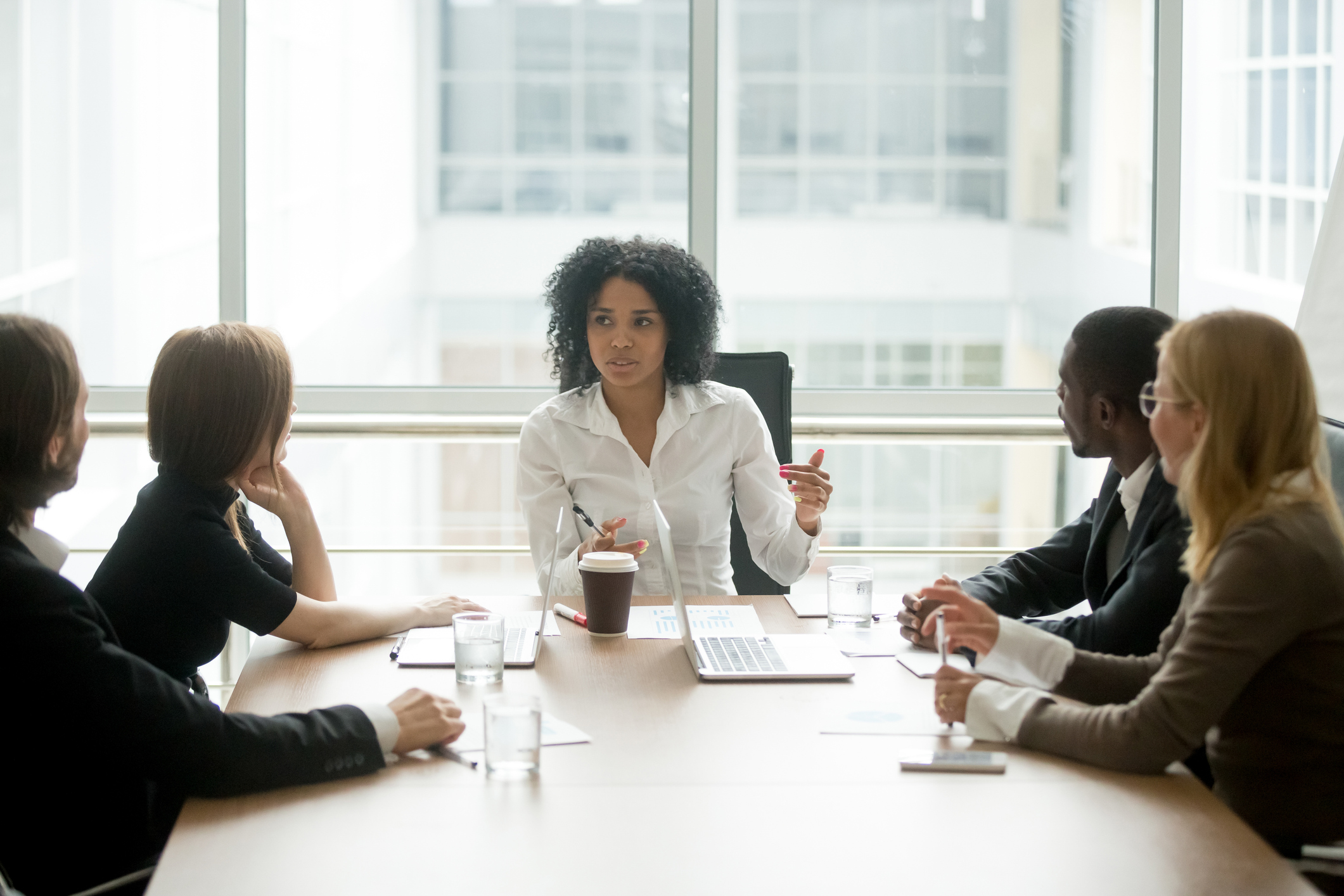 Black-female-boss-leading-corporate-meeting-talking-to-diverse-businesspeople-923039680_2125x1416